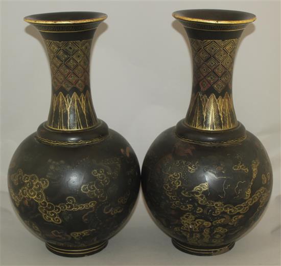 A pair of Chinese gilt and polychrome decorated black lacquer bottle vases, early 20th century, 44cm